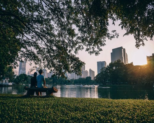 A serene view of people strolling peacefully in an open urban park